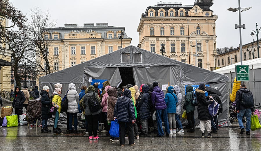 Women who fled the war in Ukraine prepare to pick up clothes from an aid point near the train station in Krakow, Poland, on March 31.