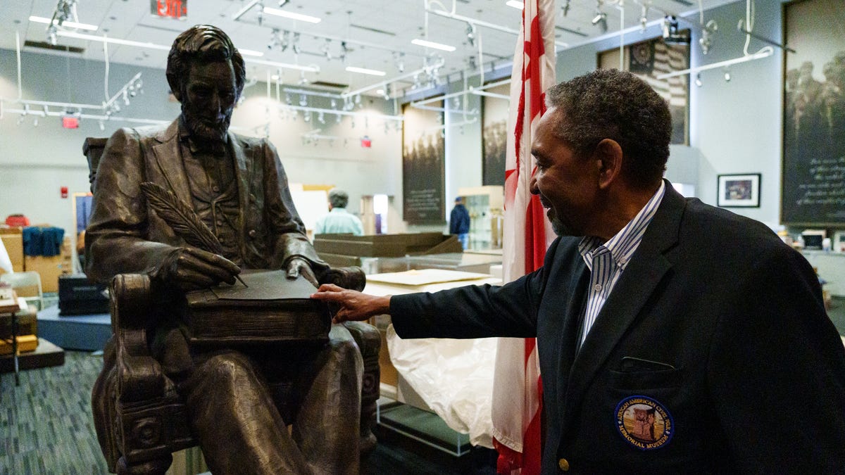 Frank Smith, the executive director of the African American Civil War Museum in Washington, D.C., showed a statue May 11, 2022 of President Abraham Lincoln signing the Emancipation Proclamation that will be displayed in the museum's new location later this year. The museum will host a Juneteenth event dedicated to Black soldiers who  fought in the Civil War.
