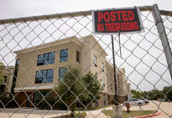 No Trespassing signs are posted at a city-owned vacant hotel on Pecan Park Boulevard on Friday May 13, 2022, after it was vandalized.  The former Candlewood Suites was purchased by the city of Austin to house homeless people.