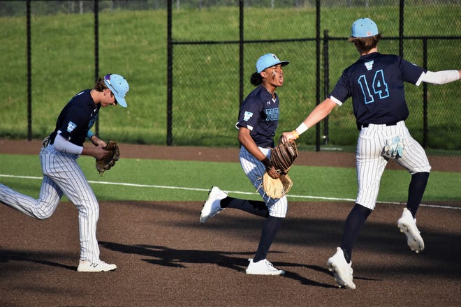 Father Tolton's Cameron Lee, middle, celebrates with Lucas Wietholder (14) after turning a double play against Southern Boone during the Trailblazers' 8-6 win over the Eagles on May 12.
