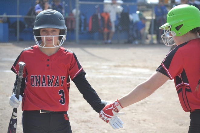 Onaway's Taylor Larson (left) gets congratulated by a teammate during a recent doubleheader at Inland Lakes. The Cardinals swept Gaylord St. Mary in a road doubleheader Thursday.