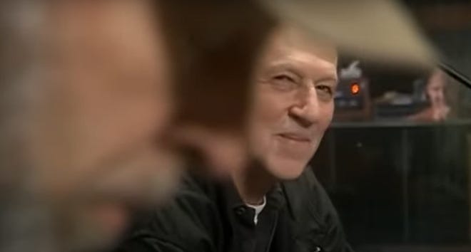 Werner Herzog watches Richard Thompson play guitar in a still from the video for "Treadwell No More," a track on "Music from Grizzly Man."