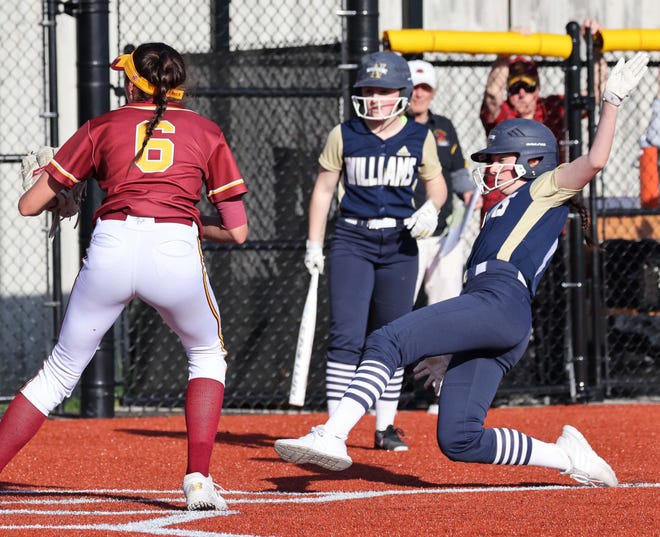 Archbishop Williams Emma O'Neil scores a run as Cardinal Spellman pitcher Ava Loud waits for the throw during a game on Thursday, May 12, 2022. . 