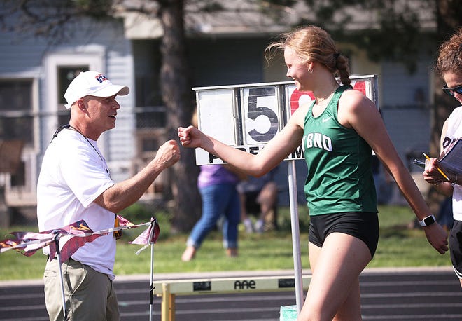 West Burlington-Notre Dame's Katy Stephens gets a fist bump from coach Corey Lamm after wining the girls high jump Thursday at Mount Pleasant.