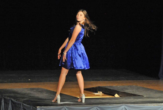 Quincy High School student Megan Caldwell strikes a pose as she models one of her designs during the Quincy High School Fashion Show, Thursday, May 12, 2022.