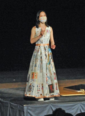 Quincy High School student Gian Zheng models her "eco-friendly" design of recycled materials used to make this dress during the Quincy High School Fashion Show, Thursday, May 12, 2022. Tom Gorman / For The Patriot Ledger