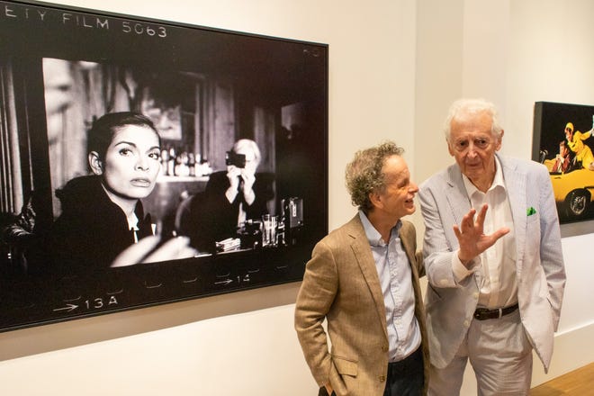 Holden Luntz, left, and Harry Benson at the opening of “The Immediate Image” exhibit. Behind them is Harry Benson's photo 'Andy Warhol and Bianca Jagger at The Factory.'