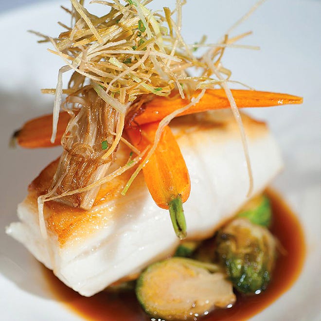 Entrees at PB Catch include Chilean sea bass with caramelized Brussels sprouts, glazed baby carrots and beech mushrooms.