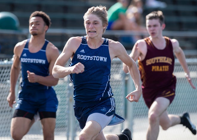 Rootstown's Nick Roberts, center, and Donovan Birkett, left, delivered individual championships in the 100 and 400, respectively, to help lift the Rovers to their first league title since 1993.