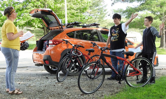 Kristy Henderson goes over bicycling signaling and other safety tips with Brady Allen and Mason Edington of the Coshocton Opportunity School. Bicycles and equipment were donated and the course started to remember Cindy Fry.