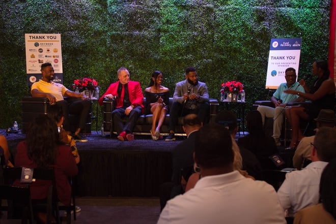 (L to R) Calvin Johnson, Darren McCarty, Letha Atwater, Braylon Edwards, Andre Rison and Rebekah Sharpe talk during the second panel discussion at the Detroit Walk & Talk charity event in Detroit, Michigan on Thursday, May 12, 2022. 