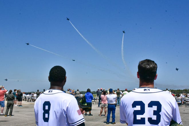 Blue Wahoos players Thomas Jones (8) and Colton Hock (23) watch the Blue Angels practice at NAS Pensacola on Wednesday.