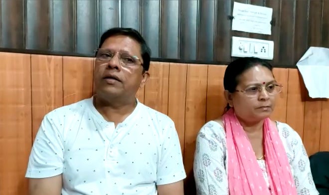 This image from video shows Sanjeev Ranjan Prasad, a 61-year-old retired government officer, and his wife Sadhana Prasad wait at a lawyer's chamber in Haridwar, India, Thursday, May 12. The Indian couple has sued their pilot son and daughter-in-law in a court demanding a grandchild within a year or compensation of 50 million rupees ($675,675). Prasad said this was an emotional and sensitive issue for him and his wife and they cannot wait any longer. His son got married six years ago.
