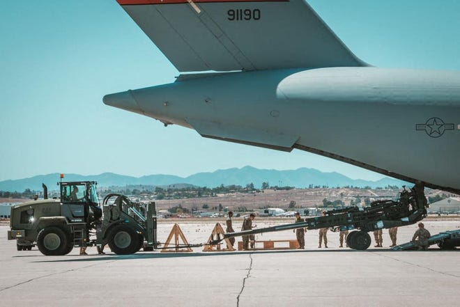 A U.S. Marine Corps M777 towed 155 mm howitzer is loaded into the back of a U.S. Air Force C-17 Globemaster III aircraft at March Air Reserve Base, California, April 23, 2022. The howitzers are part of the United States efforts, alongside allies and partners, to identify and provide Ukraine with additional capabilities. Handout photo courtesy of the US Marine Corps obtained on April 27, 2022.