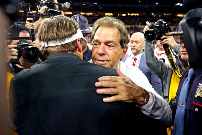 Alabama head coach Nick Saban and Georgia head coach Kirby Smart embrace after the Bulldogs' win in the national title game.