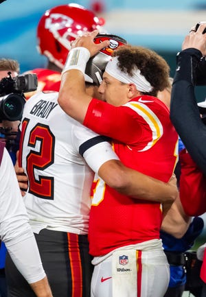Tom Brady and Patrick Mahomes hug in midfield after the Bucks beat the Chiefs in Super Bowl 55.