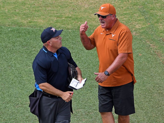Texas softball coach Mike White discusses a call with an umpire during a game against Oklahoma State last season. White drew some criticism at the