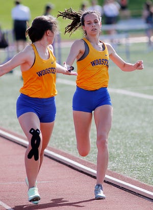 Wooster High School's Rachel Cornelius takes the baton from Marion Dix as they compete in the 4x800 meter relay at the Ohio Cardinal Conference track meet held at Ashland University on Friday, May 13, 2022. TOM E. PUSKAR/TIMES-GAZETTE.COM