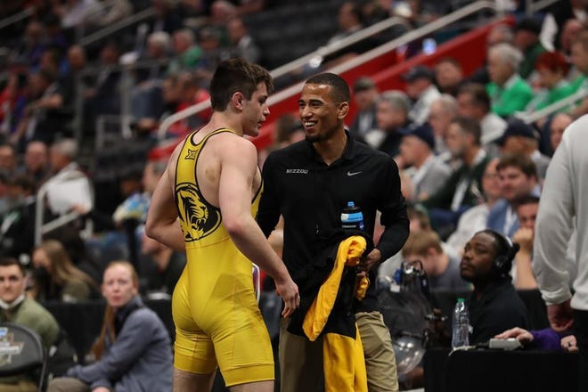 Missouri assistant wrestling coach Kendric Maple (right) coaches up a MU wrestler in March 2022. Maple lost a bet from Tigers wrestler Keegan O'Toole and wrestled in the U.S. Open.