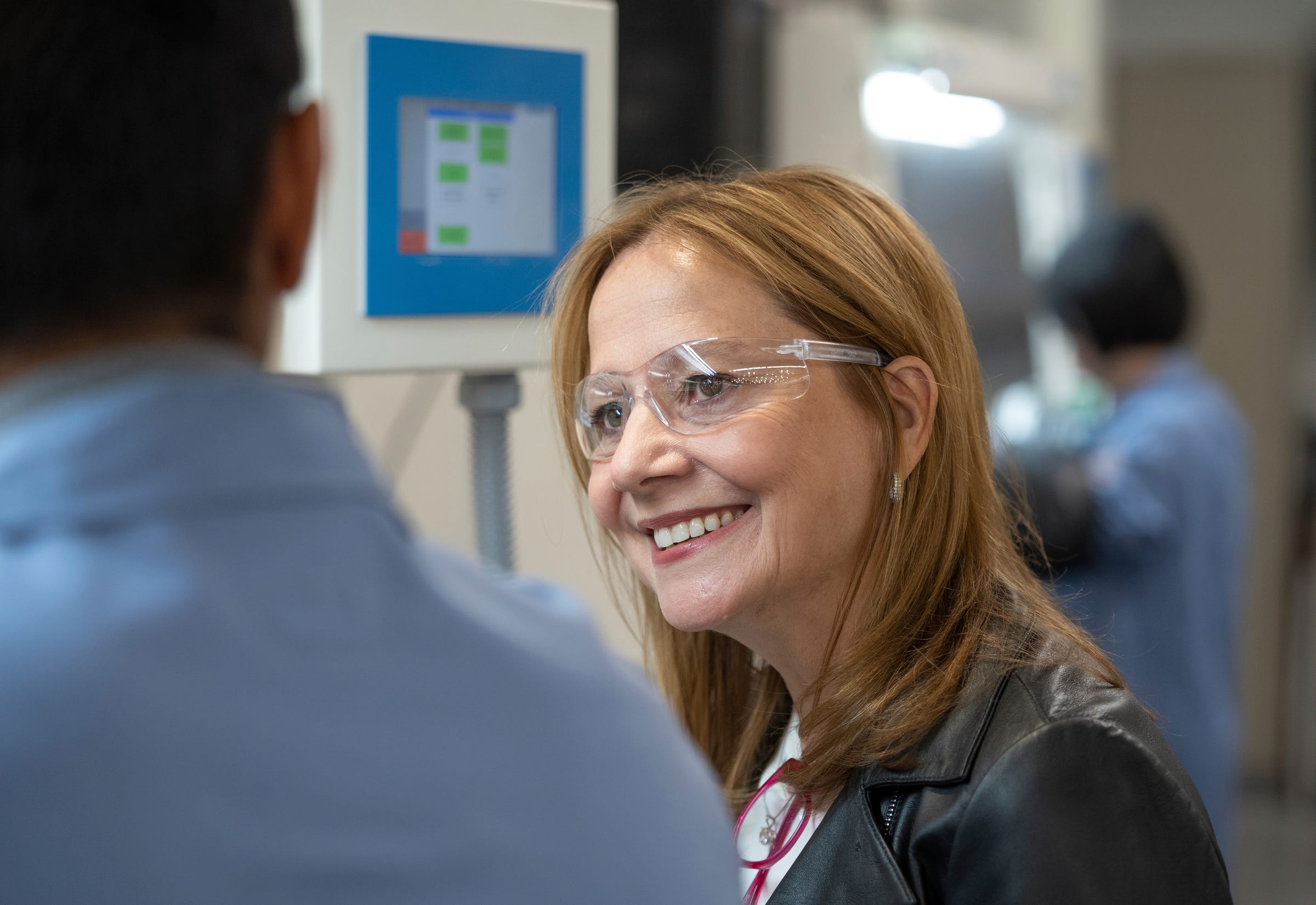 General Motors Chair and CEO Mary Barra listens to researcher Hernando Gonzalez speak about what he does while working in the materials lab at the Research and Development building of the GM Global Technical Center campus in Warren on May 3, 2022.