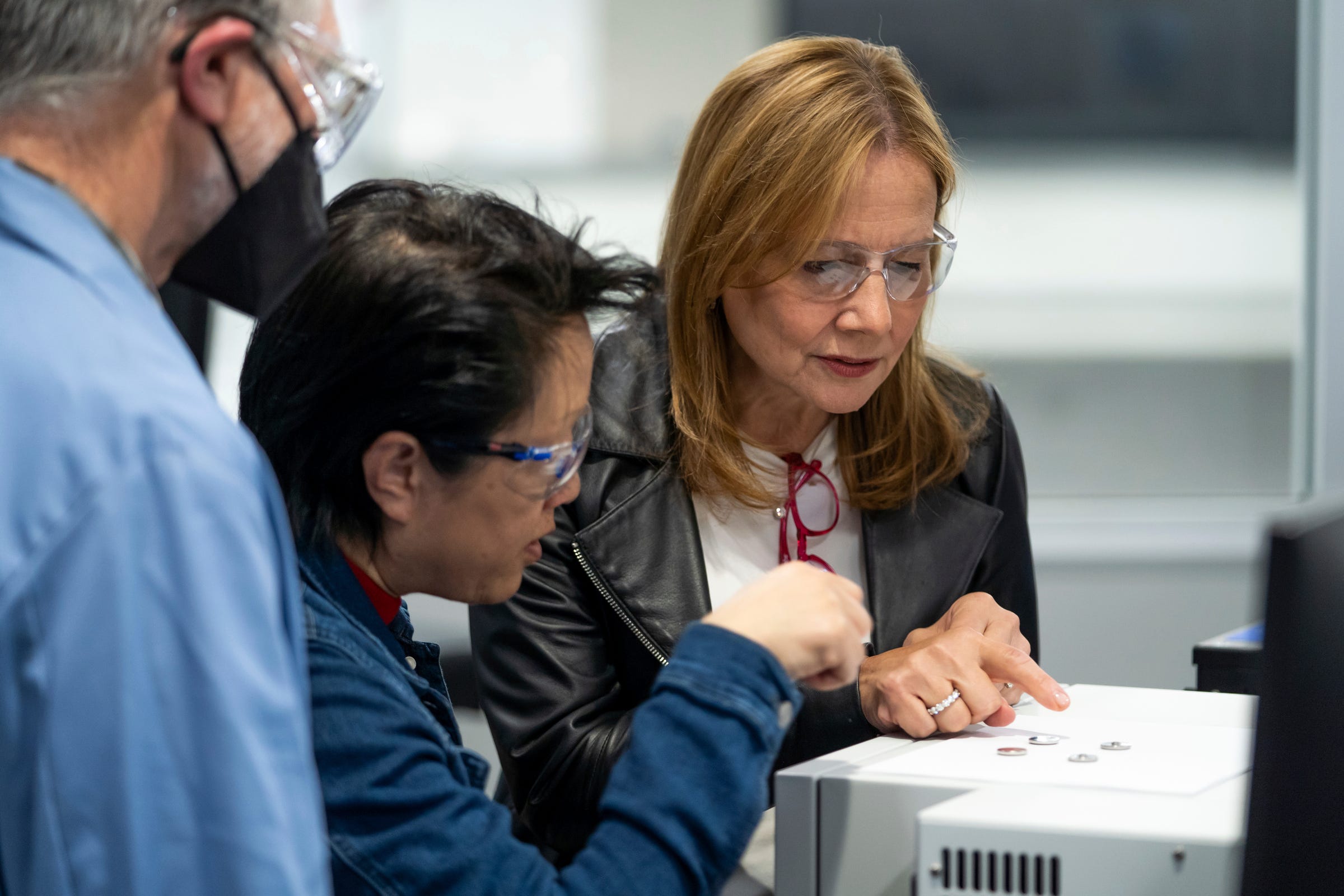 General Motors Battery Cell Systems Research Director Mei Cai, center, talks about the patented technology for battery cells she created to General Motors Chair and CEO Mary Barra in the materials lab at the Research and Development building on the GM Global Technical Center campus in Warren on May 3, 2022.