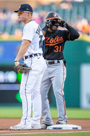 Orioles center fielder Cedric Mullins smiles and puts his hands up to his eyes after hitting a single as he stands next to Tigers first baseman Spencer Torkelson during the first inning on Friday, May 13, 2022, at Comerica Park.