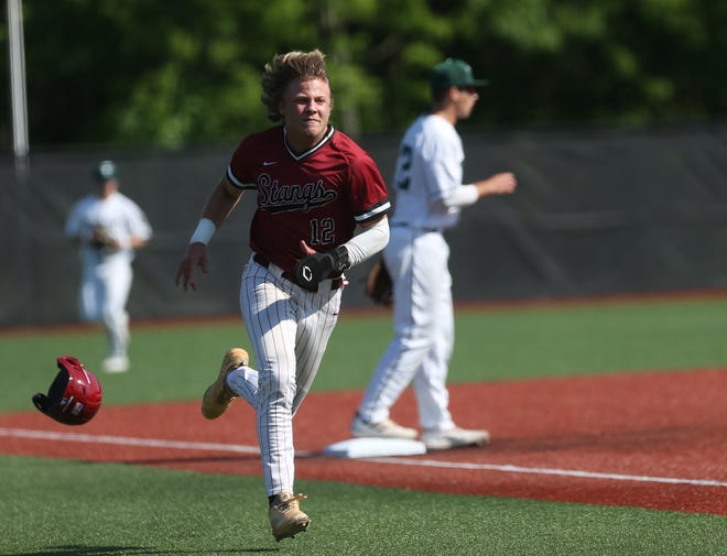 McCracken’s Dylan Riley comes in for the score against Trinity.May 14, 2022