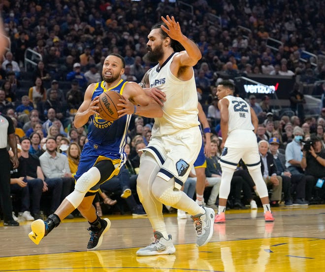 Golden State Warriors guard Stephen Curry drives to the basket against Memphis Grizzlies center Steven Adams during the first half of Game 6 of an NBA basketball Western Conference playoff semifinal in San Francisco, Friday, May 13, 2022. (AP Photo/Tony Avelar)