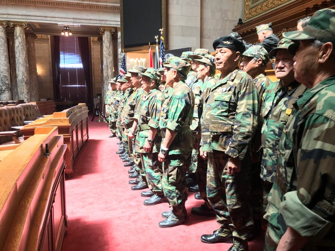 Hmong veterans of the Secret War, the CIA's covert operation during the Vietnam War that recruited Hmong soldiers to fight Communist forces in neighboring Laos, line up for photos in the Assembly chambers of the state Capitol in Madison on Saturday, May 14, 2022, recognized by state law as Hmong-Lao Veterans Day in Wisconsin.