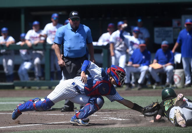 Reno's Kaden Schuck tags out Bishop Manogue's Sam Kane at home plate to complete a double play and record the final out to win the NIAA North 5A regional baseball championship Saturday.