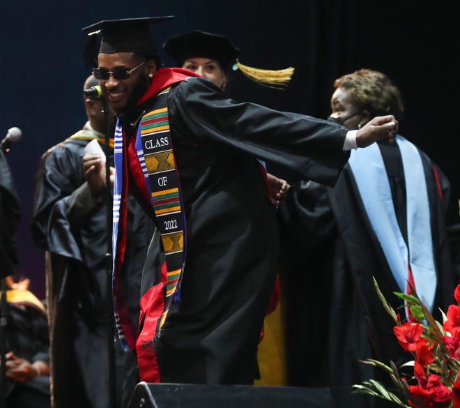 Graduate Kevante Dawson dances as he receives his diploma during Delaware State University's 2022 commencement ceremonies in Memorial Hall, Saturday, May 14, 2022.