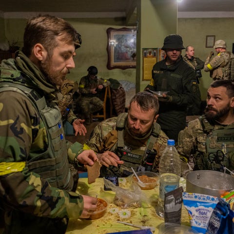 Ukrainian National Guard soldiers gather in a hous