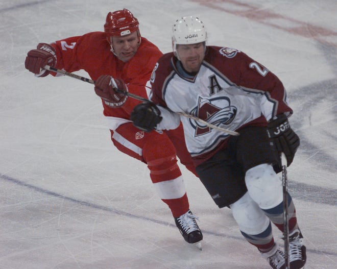 Wings' Slava Fetisov tries to slow down Avalanche's Claude Lemieux during Game 2 of the West finals at McNichols Sports Arena in Denver, May 17, 1997.