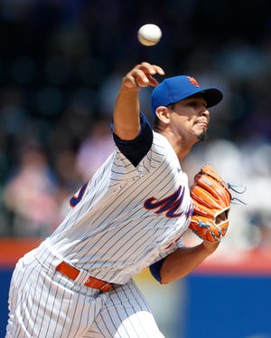 New York Mets starting pitcher Carlos Carrasco throws against the Seattle Mariners during the first inning of a baseball game Sunday, May 15, 2022, in New York. (AP Photo/Noah K. Murray)