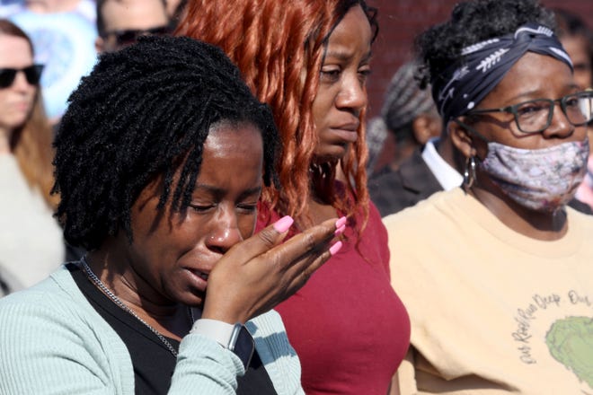 Takesha Leonard of Buffalo, N.Y. cries during a prayer vigil May 15, 2022 across the street from the Tops supermarket in Buffalo where a gunman killed ten people Saturday.