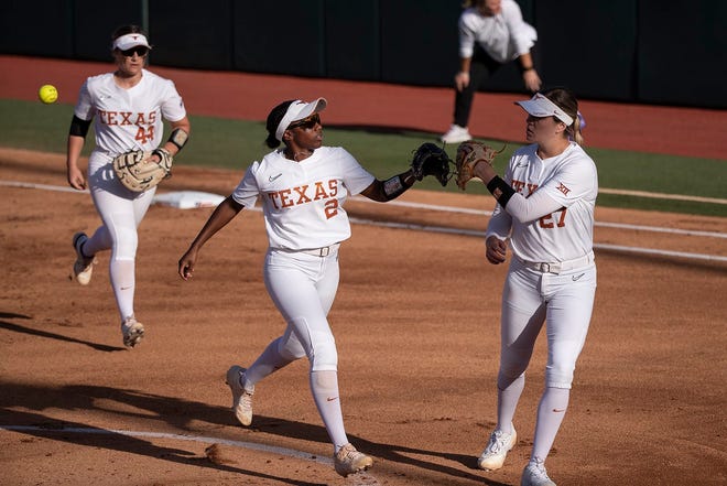 Texas' Janae Jefferson, center, and Hailey Dolcini fist-bump during a game against Oklahoma in April. Jefferson had three hits, including a homer, as the Longhorns beat Weber State 6-0 Friday in the NCAA Seattle Regional.