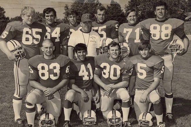 For one season, Monmouth alumnus Ken Geiger (in center) left high school coaching and joined the Fighting Scots staff. He’s pictured with Monmouth players he also coached in high school. In front, from left, are Paul Waszak, Mike Castillo, Bill Dusek and George Kokenes. In back, from left, are Dave Brinker, Bob Trombetta, Bill Honeycutt, Tom Kratochvil, Greg Derbak and John Unterfranz.