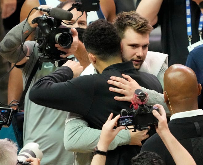 May 15, 2022;  Phoenix, Ariz.  US;  Phoenix Suns guard Devin Booker (1) congratulates Dallas Mavericks guard Luka Doncic (77) after game 7 of the Western Conference semifinals at Footprint Center.