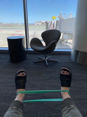 Low tech: Jolly travels with a Theraband, which she uses to stretch while killing time at the airport.