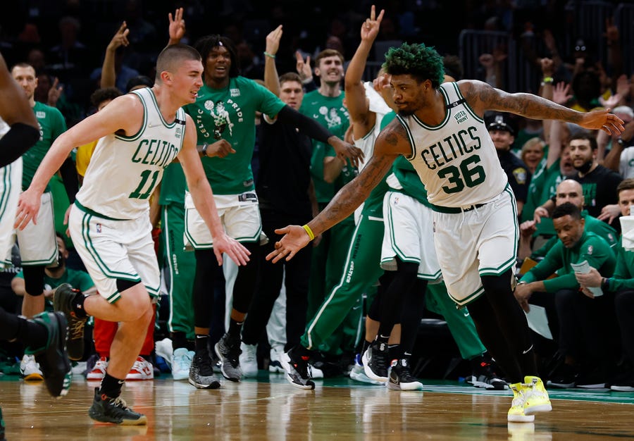 The Celtics' Marcus Smart (36) and Payton Pritchard  celebrate after a three-point basket against the Bucks during Game 7.