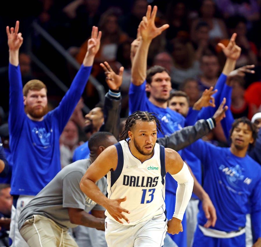 Jalen Brunson (13) and the Mavericks bench reacts after a play against the Suns in Game 7.