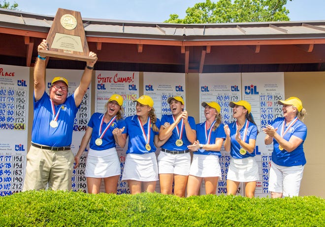 Anderson's golf coach John McPherson holds high the Class 5A state championship trophy and celebrates with his team during the awards ceremonies at the girls state golf tournament Tuesday at White Wing Golf Club in Georgetown. Anderson edged Alamo Heights by one stroke, and Anderson junior Farah O'Keefe won individual honors.
