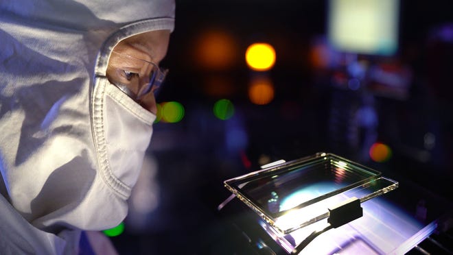 An Intel engineer inspects a mask as part of the Intel Mask Operation in Santa Clara, California. The mask operation team builds the masks used as the templates to print circuitry onto a silicon wafer. To create a mask, engineers use computerized drawings that are the blueprints for Intel processors and their billions of transistors. (Credit: Tim Herman/Intel Corporation)
