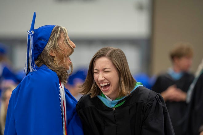 Senior Sam Schube and English teacher Stephanie Wilson at Wellington High School's graduation at the South Florida Fairgrounds in May.