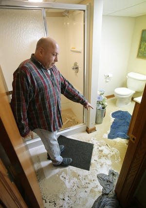 North Canton resident Dan Schoenberg stands in his basement that was recently flooded with raw sewage.