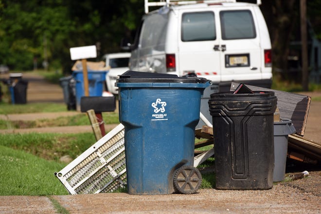 Trash lines Hair Street in Jackson, Miss. on pick-up day Tuesday, May 17. About a month before, the city of Jackson replaced Waste Management with Richard's Disposal taking over the city's residential collection.