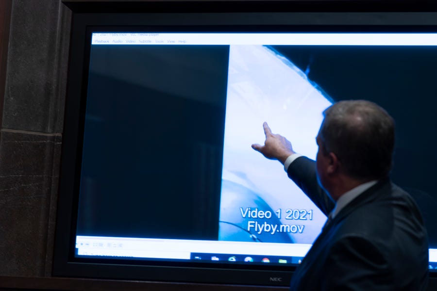 Deputy Director of Naval Intelligence Scott Bray points to a video display of a UAP during a hearing of the House Intelligence, Counterterrorism, Counterintelligence, and Counterproliferation Subcommittee hearing on "Unidentified Aerial Phenomena," on Capitol Hill, Tuesday, May 17, 2022, in Washington.