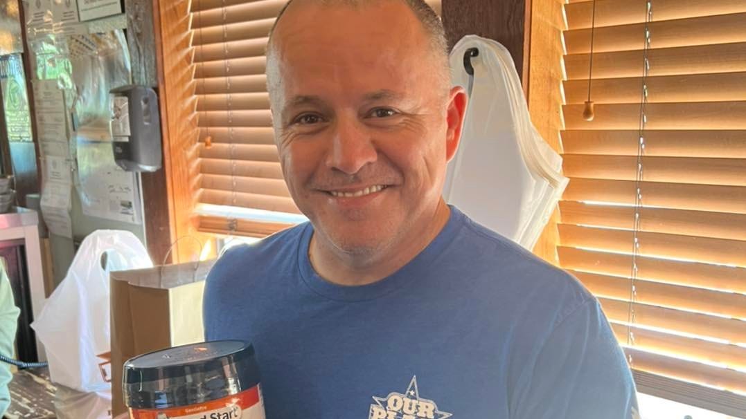 Benji Arslanovski, owner of Our Place Restaurant, and a can of Gerber's Gentle Pro infant formula.