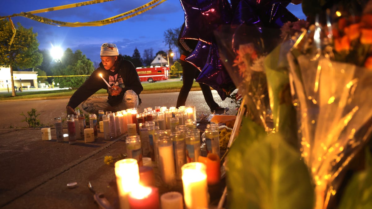 Mourners light candles at a makeshift memorial outside of Tops market on May 16, 2022 in Buffalo, New York.