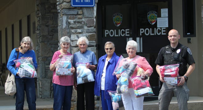Officer Brad Demuth joined the women's mission group of FBC Swannanoa on May 16 as the group brought donations for children experiencing trauma.